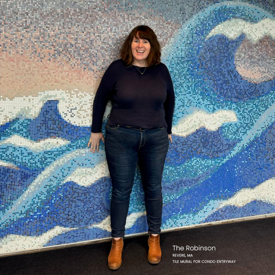 Meagan OBrien smiling in front of her tile mural for The Robinson building in Revere, Massachusetts